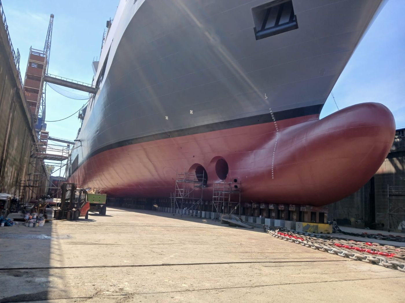 Bow of a large vessel in dry dock, hull coated below the waterline